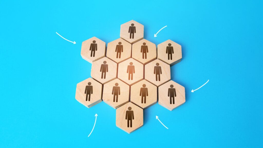 Wooden hexagons with human icons arranged in a honeycomb pattern on a blue background, connected by white arrows—ideal for illustrating animation strategy templates or showcasing animation elements in team structures.