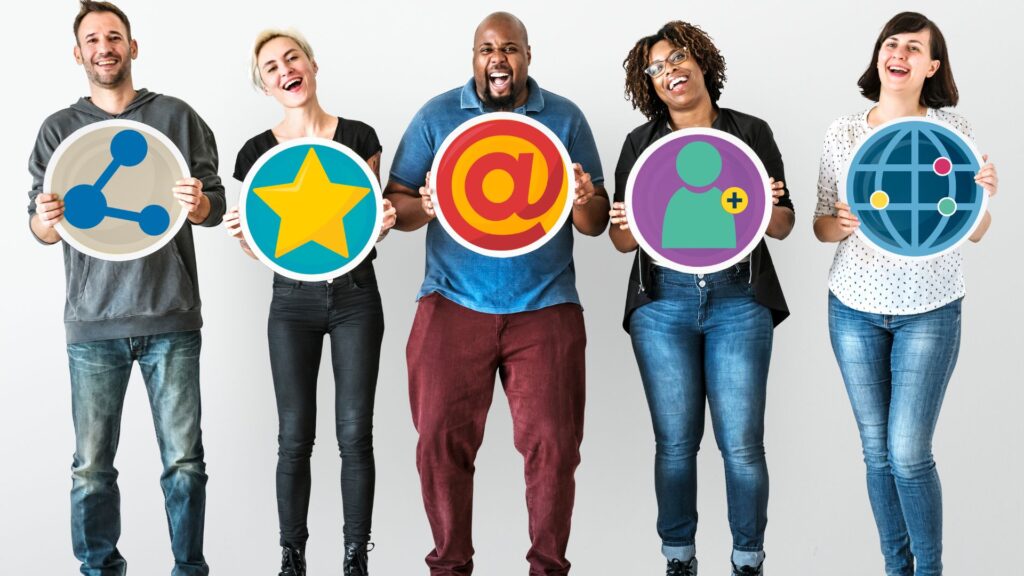 Five people stand against a white background, each holding a large round sign featuring different social media icons—perfect for showcasing animation for email marketing campaigns.