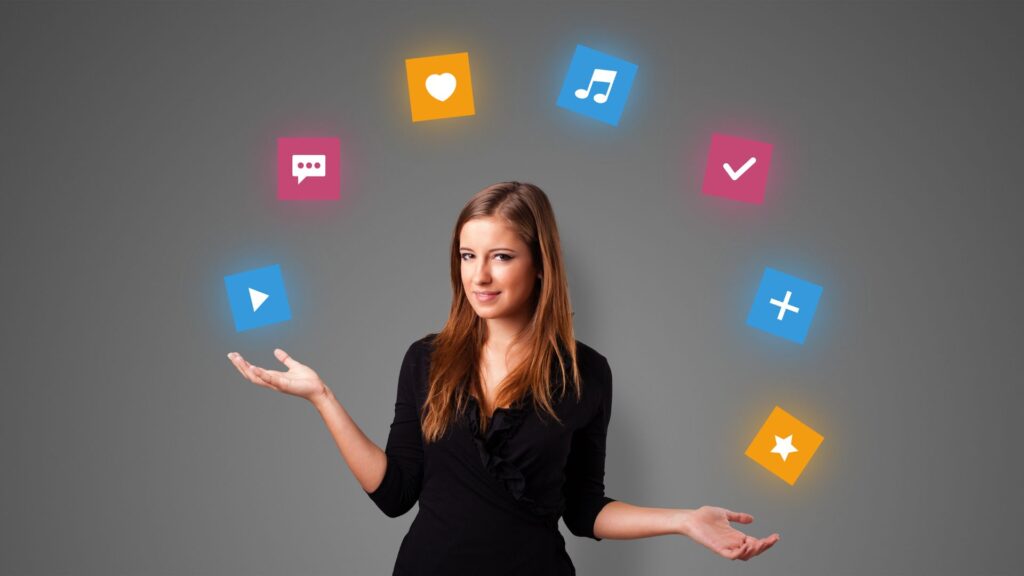 A woman stands with arms outstretched, surrounded by floating colorful icons representing various media and social functions, visually capturing the impact of Social Media Animation Services against a gray background.