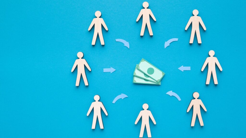 Paper cutout figures arranged in a circle around a stack of money, with arrows pointing toward the cash, against a blue background—an ideal concept for an investment animation or visual investment guide.