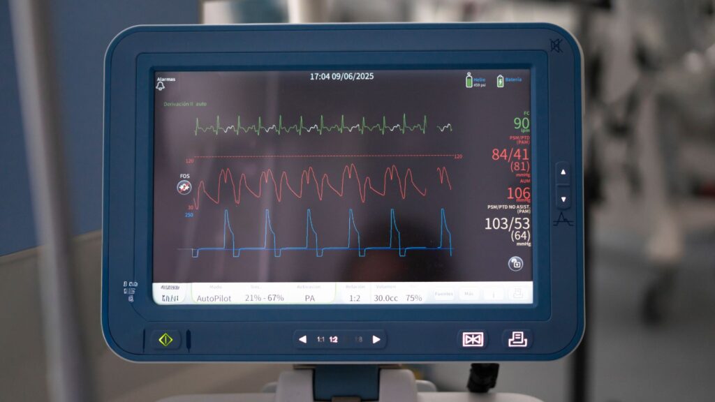 A close-up of a patient monitor displaying ECG, blood pressure, heart rate, and oxygen saturation readings in a clinical setting—perfect visuals for high impact healthcare explainer videos.